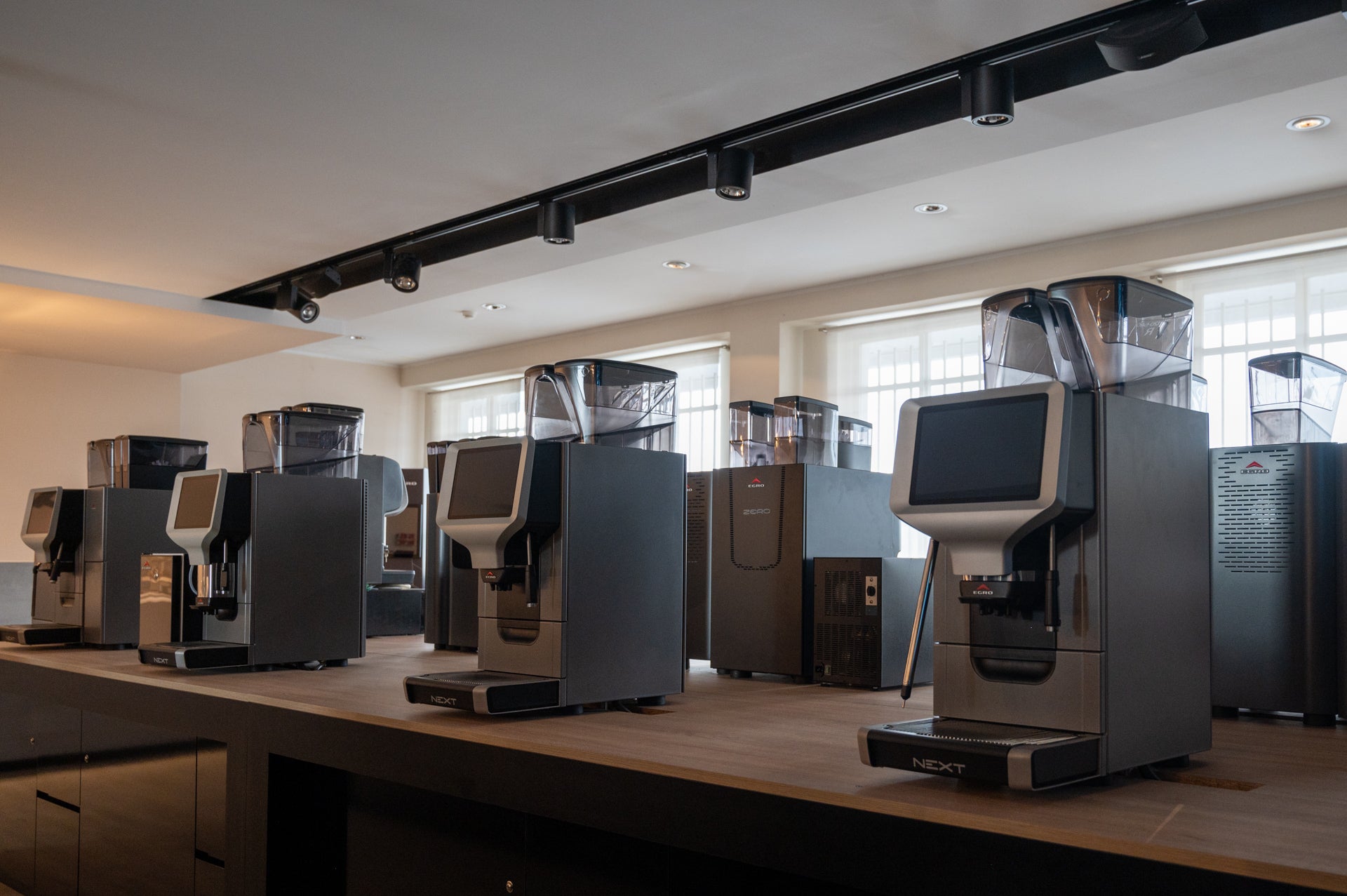 A line of Egro Espresso Machines Lined Up On A Business Counter